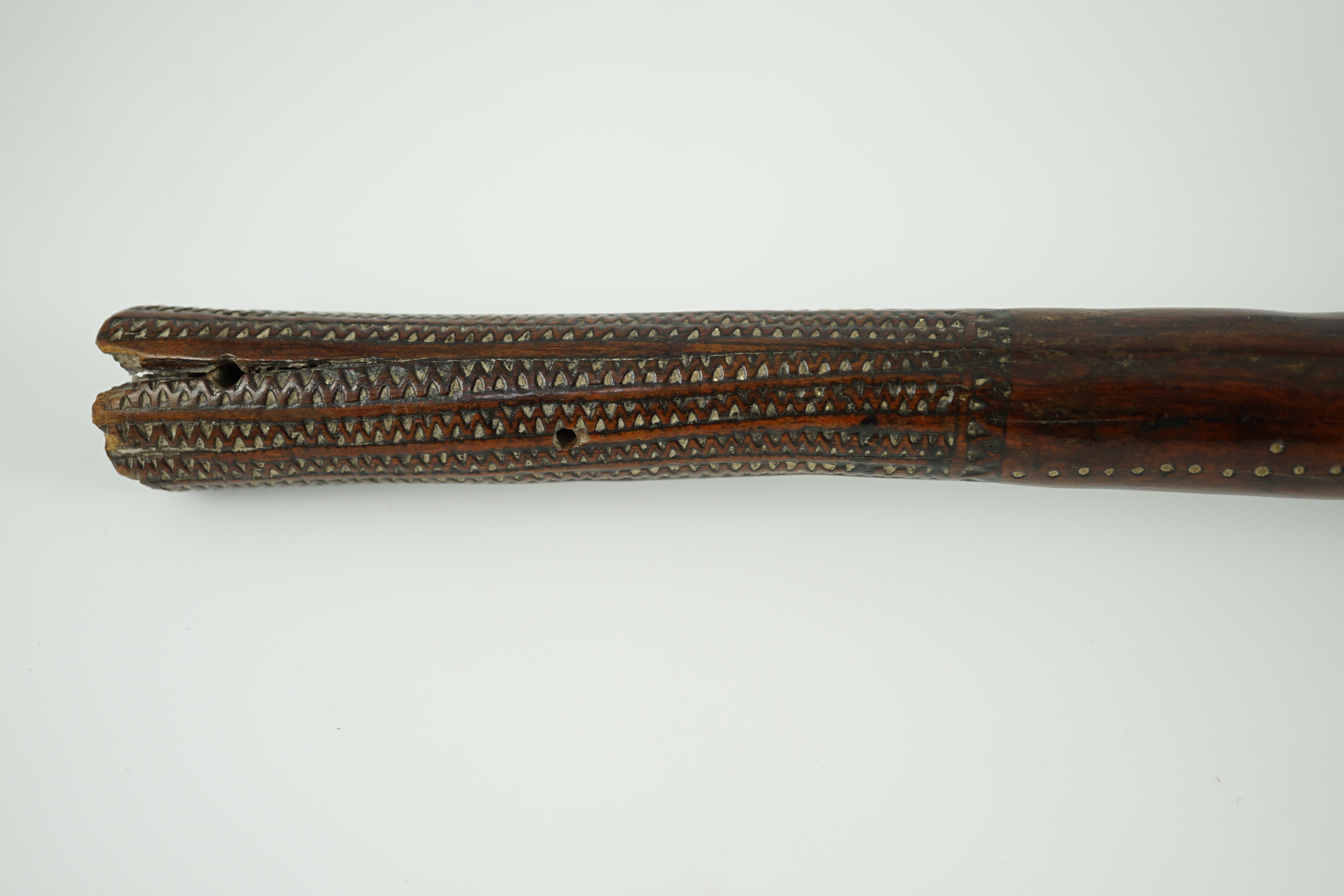 A Fijian hardwood throwing club, with zig-zag relief carved handle and further irregular spotted decoration, 40cm long